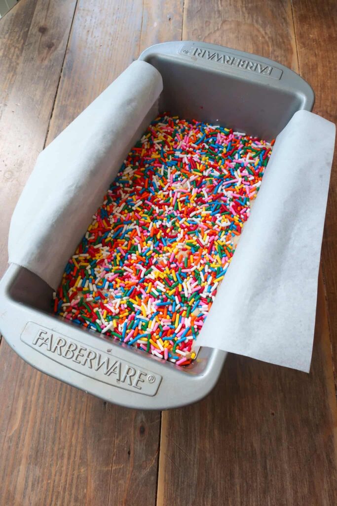 loaf pan with sugar cookie dough covered in sprinkles
