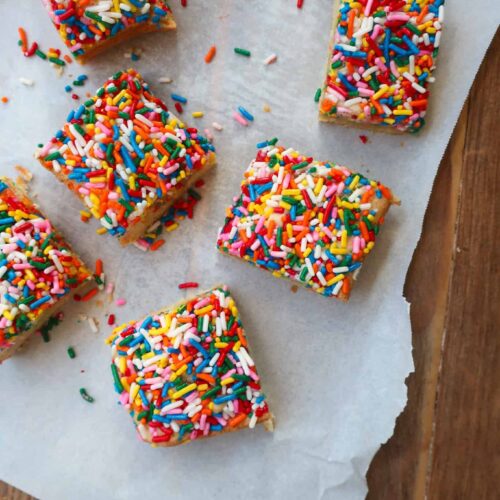 sprinkle sugar cookie bars on parchment paper