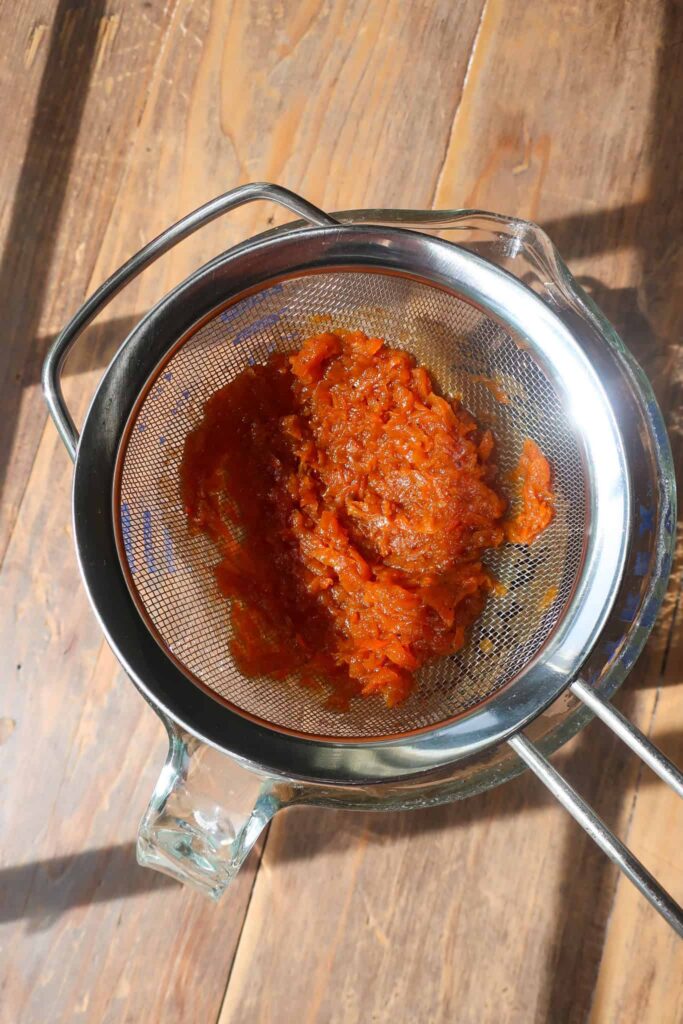 carrots cooked down and straining into pitcher