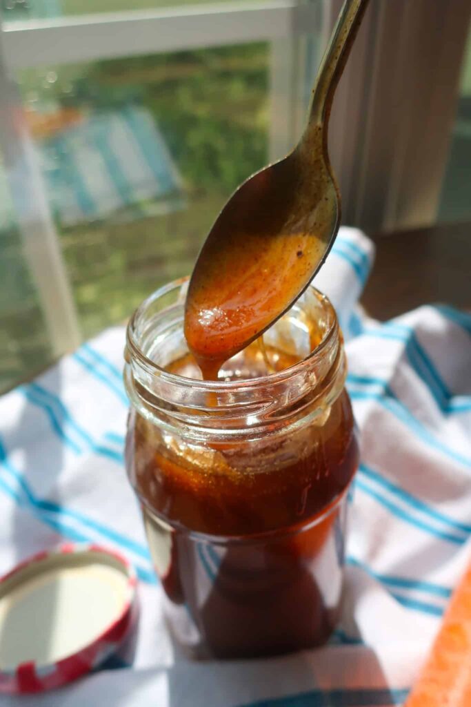 spoon pouring carrot cake sauce