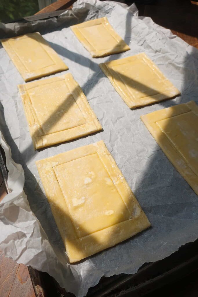 puff pastry dough cut into rectangles on baking sheet