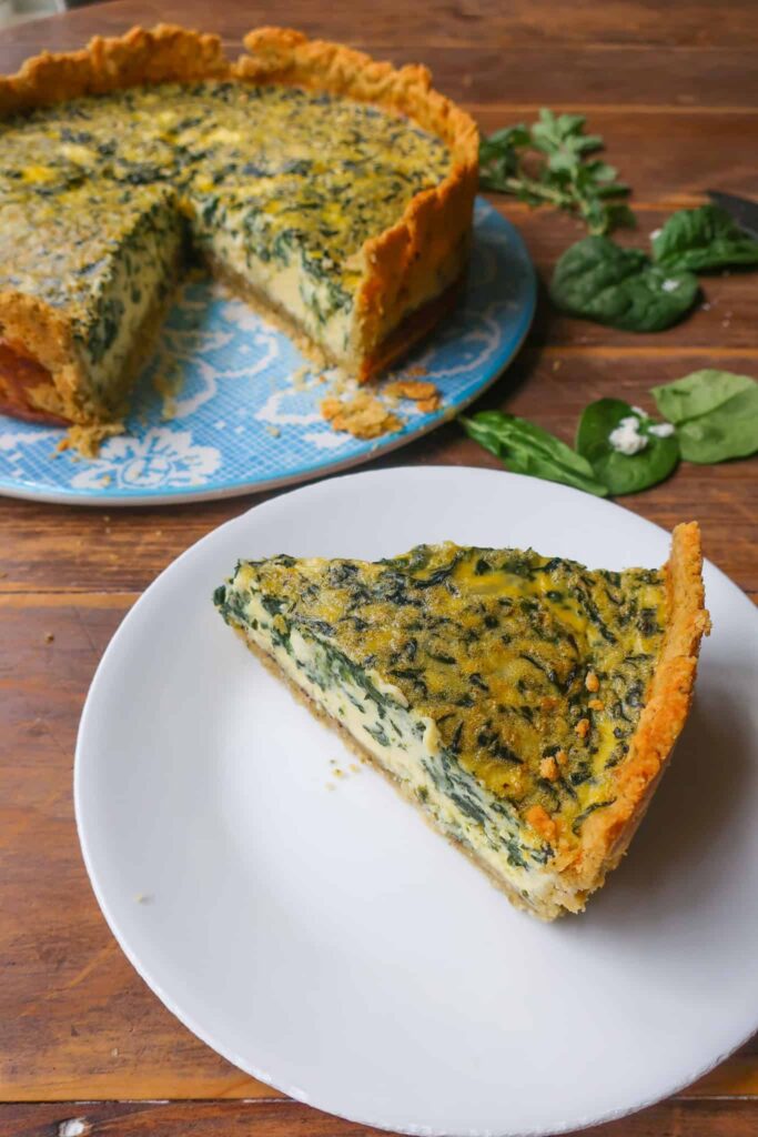 slice of spinach feta quiche on white plate