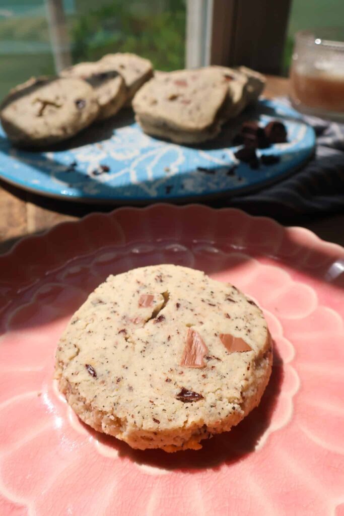 earl grey brown butter shortbread cookie with chocolate on pink plate