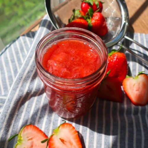 homemade fruit compote in jar on striped napkin