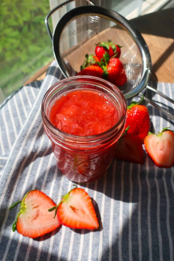 homemade fruit compote in jar on striped napkin