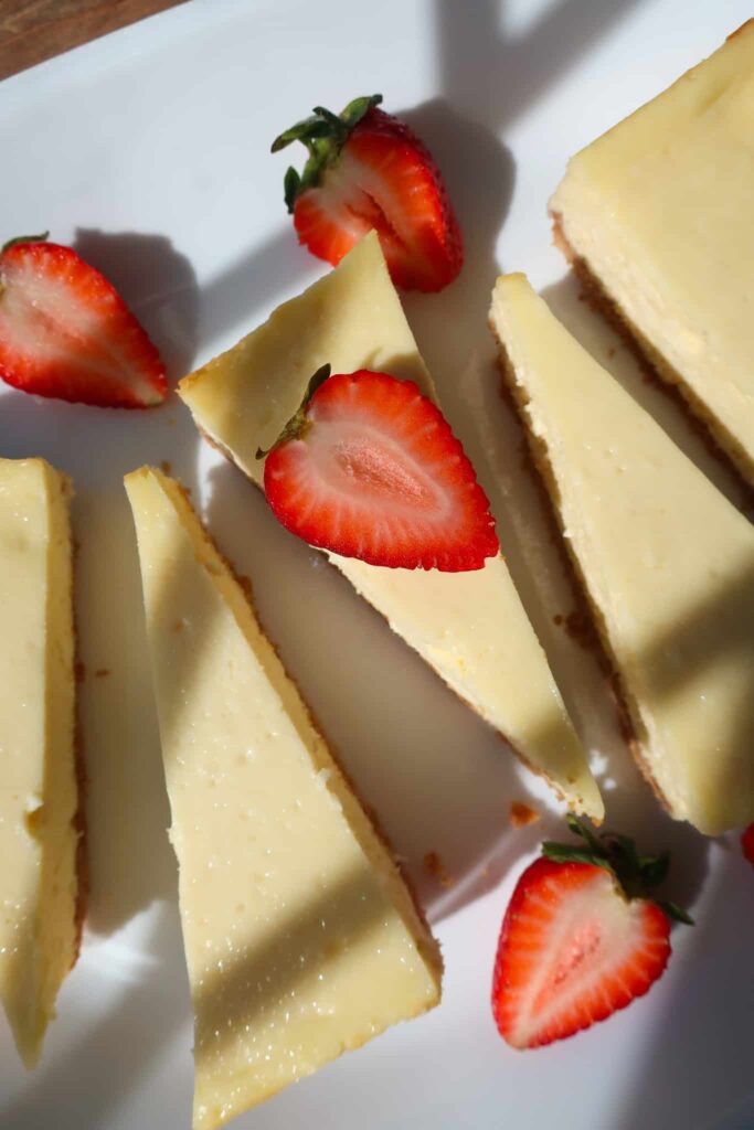 fresh cut strawberries on vanilla cheesecake