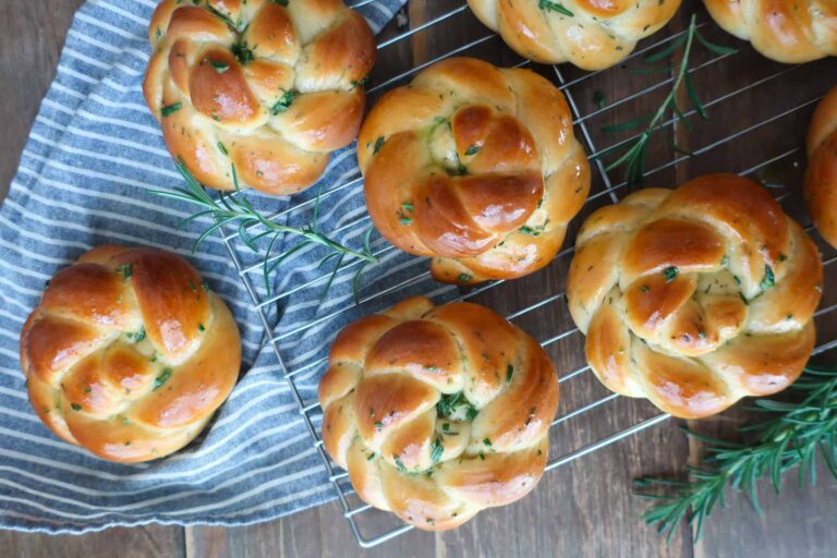 rosemary challah rolls on wire rack