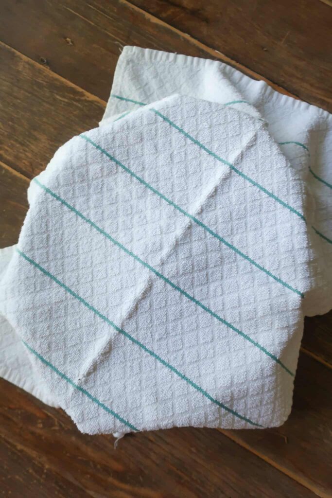 towel covering pan proofing bread dough