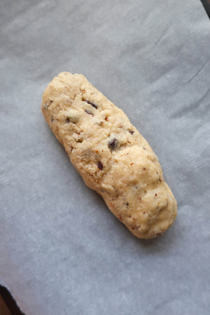 dark chocolate biscotti dough on parchment paper
