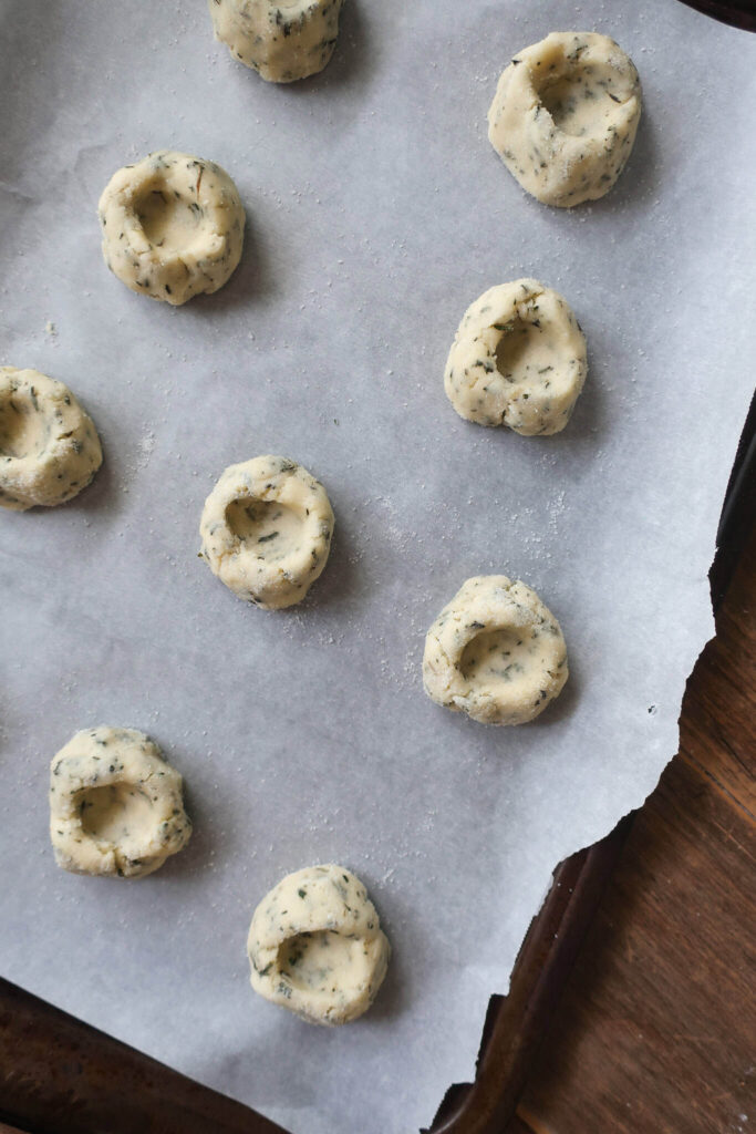 thumbprint shortbread cookie dough on baking sheet
