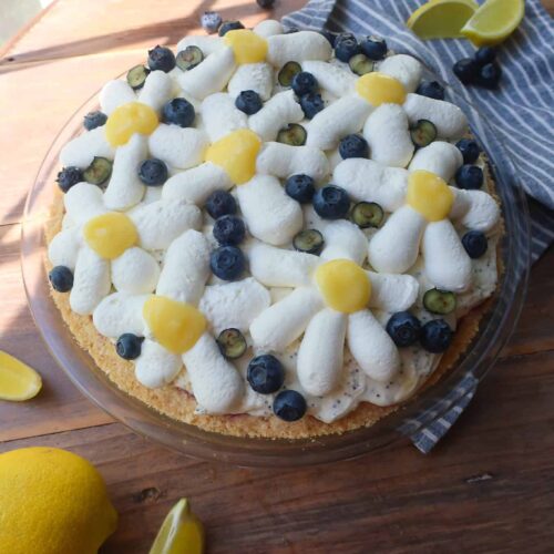 whipped cream lemon curd and blueberry flowers on top of pie