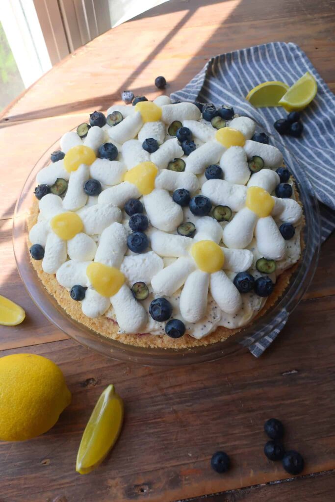 whipped cream lemon curd and blueberry flowers on top of pie