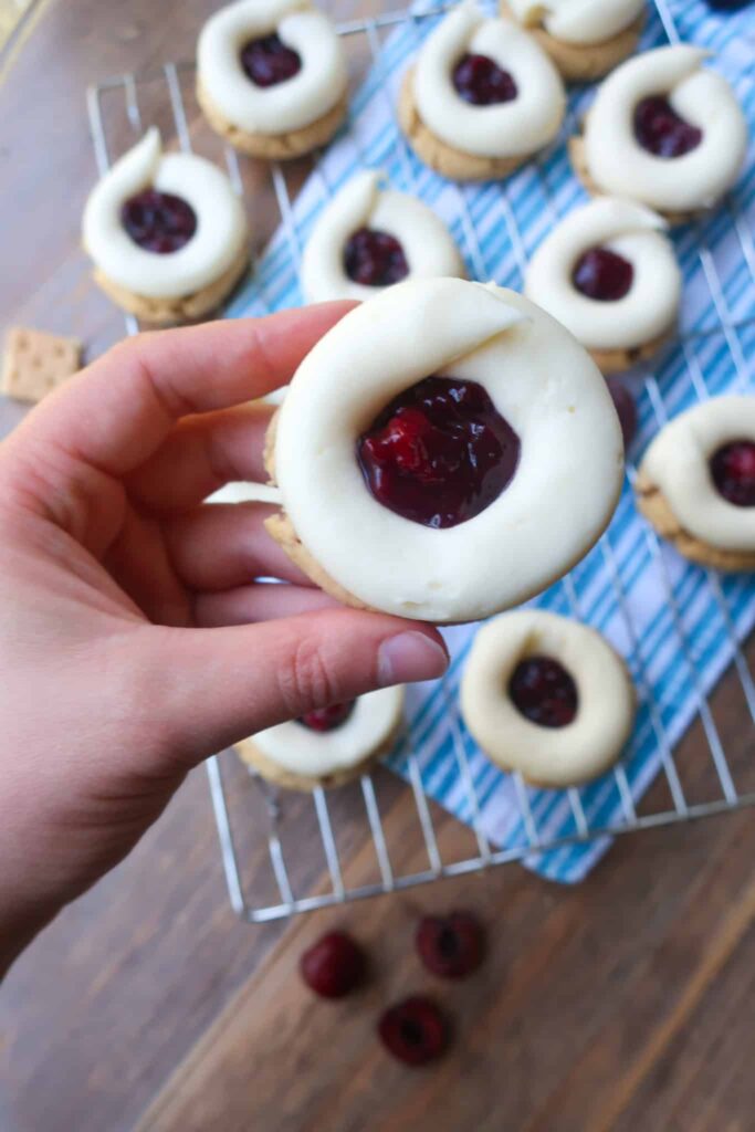 holding cherry cheesecake cookie