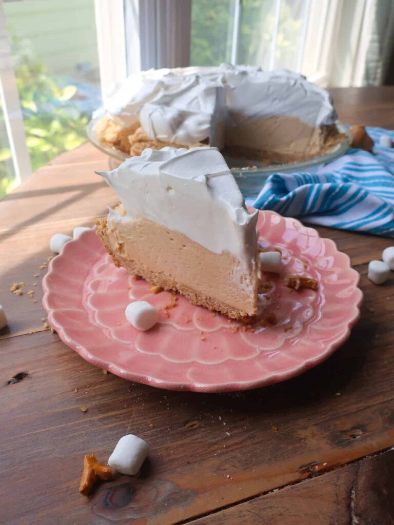 slice of peanut butter mousse pie with swiss meringue