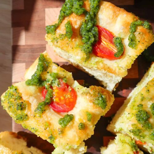 tomato pesto focaccia bread cut into squares in sun