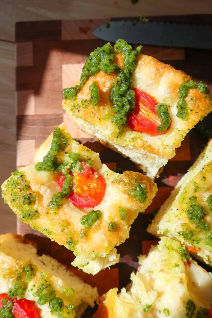 tomato pesto focaccia bread cut into squares in sun