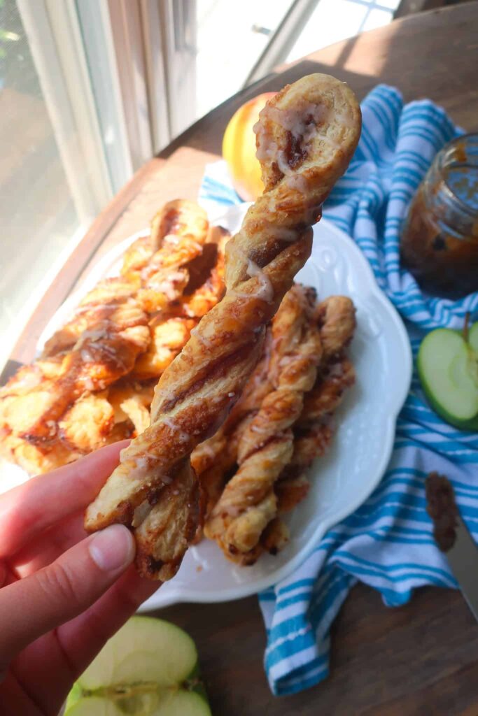 holding apple puff pastry dessert