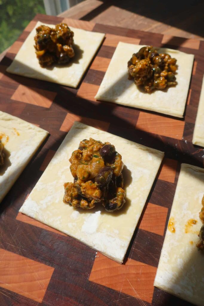 raw pastry with taco filling on top ready to assemble