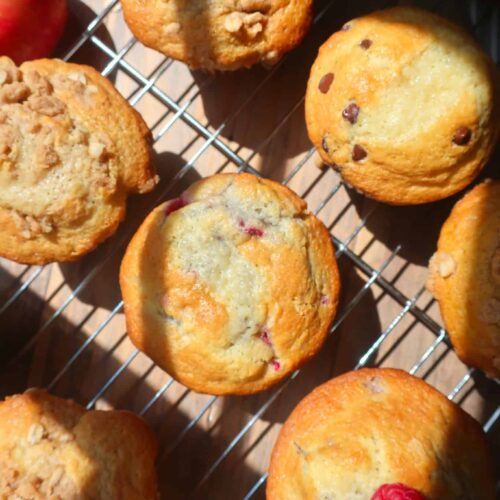 raspberry white chocolate muffins and other flavors on wire rack