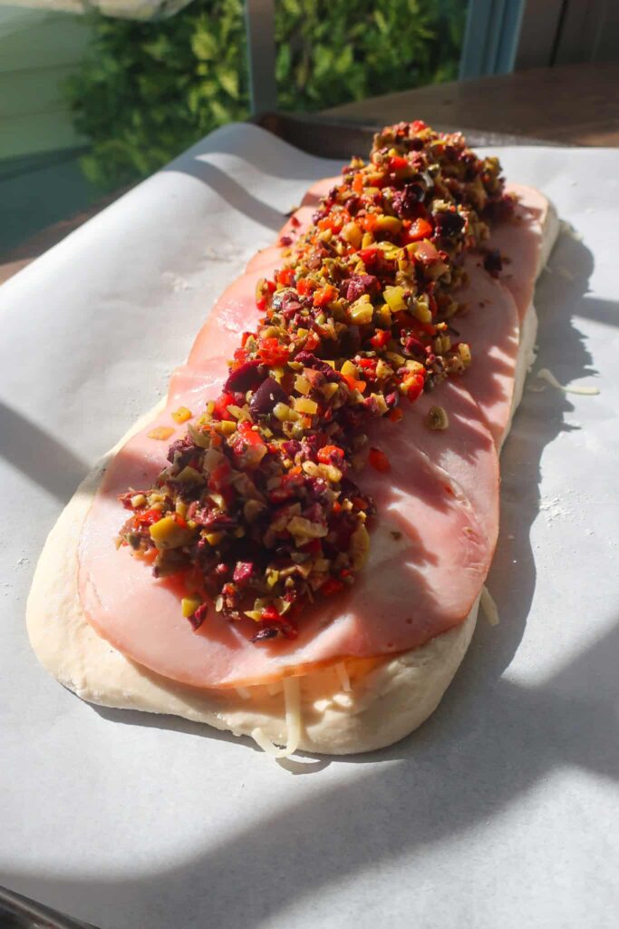 homemade olive tapenade layered with meat and cheese